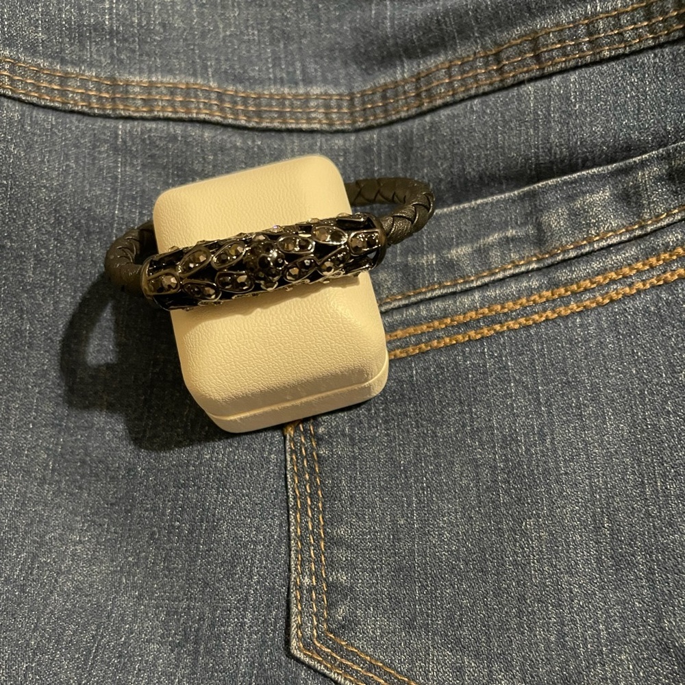 Faux-leather black bracelet, with metal and rhinestone detail. Magnetic closure